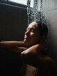 © ZHPH Production by Artem Zhushman/Stocksy - Woman in shower