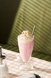 © 365mm/Stocksy - Strawberry milkshake in glass on table