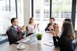 © AntonioDiaz - Multiracial business team clapping hands after a meeting