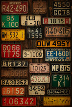 Various Retro License Plates On The Wooden Wall.