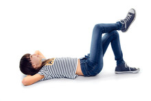 10 Year Old Girl Look Up While Lie On Ground With Legs Crossed