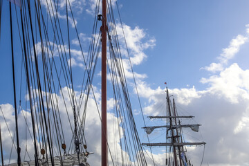 Wall Mural - Sailing ship mast against the blue sky on some sailing boats with rigging details.