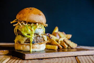 Double beef burger with cheese, onion, tomato, lettuce, bacon and fries Extra portion of potatoes.