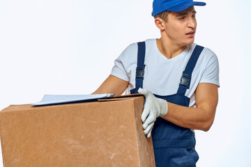 Man worker with box in hands delivery loading service work light background