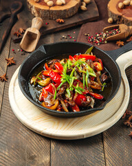 Wall Mural - Roasted beef with vegetables in cast iron pan