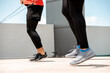 Low angle portrait of athletes doing jump rope morning exercise on outdoor rooftop