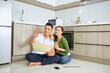 © makistock - Man and woman looking at their house plans sitting in their new house