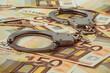 Handcuffs on the background of 50 euro