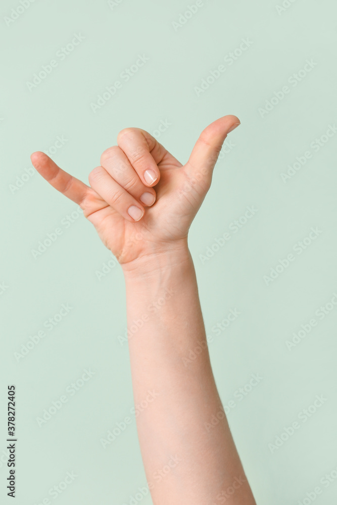 Hand showing letter Y on color background. Sign language alphabet