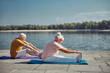 © Viacheslav Yakobchuk - Two senior beginner yogis performing a stretching exercise