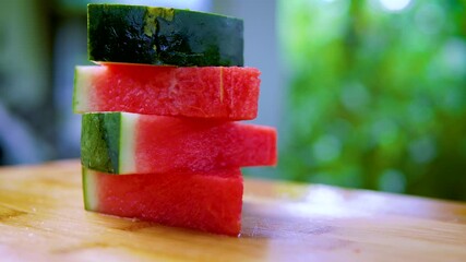 Wall Mural - Rotation of fresh watermelon slices on cutting board. Close up shot 4K