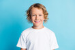 Portrait of pretty boy look in camera beaming smiling wear white t-shirt isolated over blue color background