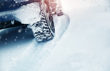 Wall Mural - Car tires on winter road covered with snow