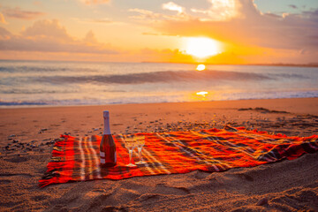 Having a picnic on the beach at sunset