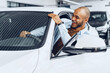 © fotofabrika - Portrait of a handsome happy African American man sitting in his newly bought car