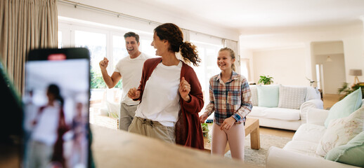 Family making dancing video on smart phone