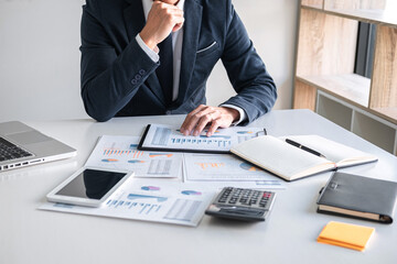 Fototapete - Business Financing Accounting Banking Concept, businessman doing finances and calculate about cost to real estate investment and in other, tax system