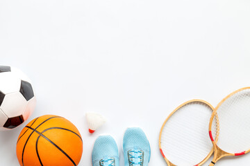 Wall Mural - Flat lay of sport balls and rackets on white background. Above view, copy space