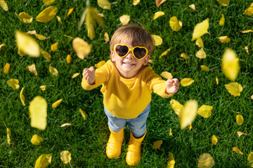 Poster - Happy child having fun outdoor in autumn park