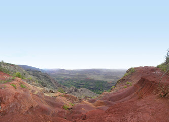 red clay Mountains and terrain with green forest in background