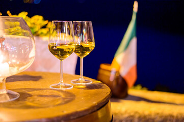 Two glasses of cold dry white wine served outdoor in cafe at night in Italy