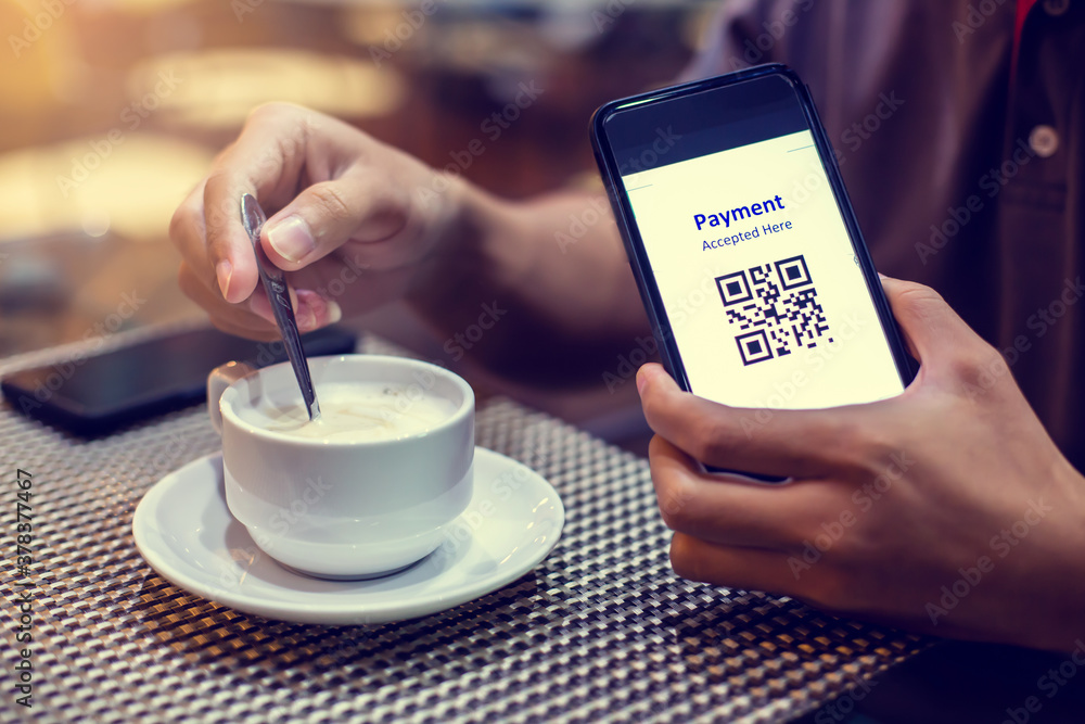 Selective focus to payment QR code tag on smartphone with coffee in ...