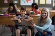 © Wavebreak Media - Portrait of female teacher and disable boy smiling while sitting in his wheelchair in class