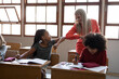 © Wavebreak Media - Female teacher and girl greeting each other by touching elbows at school