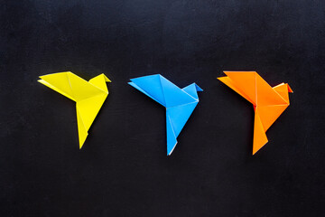 Wall Mural - Flat lay of origami flying birds. Top view