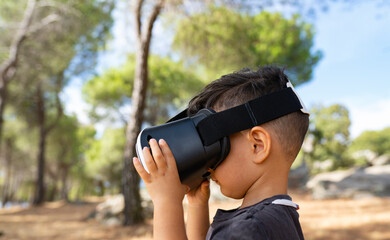Wall Mural - boy with virtual reality glasses in the forest