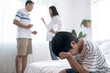 © Basicdog - Crying illtle asian boy with his fighting parents in the background, Family problems, Divorce problem.