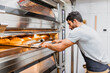 © Manu Reyes/Westend61 - Baker baking bread at bakery