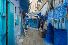 Alley Amidst Blue Buildings At Chefchaouen, Morocco