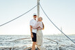 © Artem Varnitsin - Two elderly people in casuals standing on yacht bow and smiling