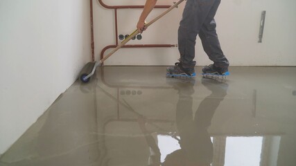 Poster - A worker rolls out the liquid floor with a trowel. Squeegee for distributing the mixture. The worker levels the liquid floor. Finishing works - Needle roller for bulk floor