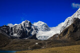 Fototapeta Krajobraz - Landscape of deep blue sky and ice capped peaks of himalayan mountains with white clouds during day time