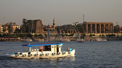 Wall Mural - Luxor Temple ancient egyptian temple complex on east bank of Nile river in Luxor. View from Nile river with boat, 4k