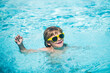 Child swimming in sea or swimming pool.