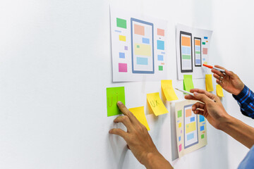 Wall Mural - the team of website designers with the ux ui system are writing programs and laying the layer to det