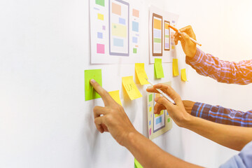 Wall Mural - the team of website designers with the ux ui system are writing programs and laying the layer to det