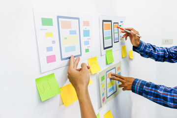 Wall Mural - the team of website designers with the ux ui system are writing programs and laying the layer to det