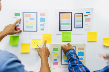 Wall Mural - the team of website designers with the ux ui system are writing programs and laying the layer to det
