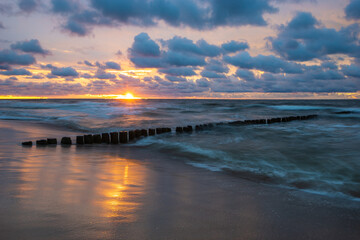 Wall Mural - sea landscape at sunset. beach, sea waves, breakwaters.