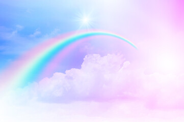 The Rainbow sky is Colorful sky with Soft clouds and a rainbow crossing. Fantasy magical sunny sky pastel background is fluffy white cloud. Freedom wallpaper concept. Sweet color dream.