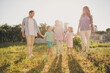 © deagreez - Full body size photo of big family five people gathering enjoy park rest hold hands countryside weekend leisure concept generation comfort fenced house green garden backyard outdoors