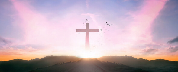 Wall Mural - religious concept: silhouette cross and birds flying on sunrise background