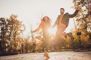 Sticker - Full body photo of cheerful girl guy jump up in fall town center october park wear season outerwear