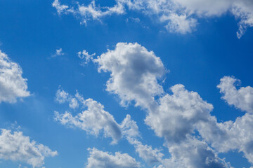 white fluffy clouds in the blue sky.