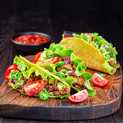 Wall Mural - Taco with ground beef meat,  mashed avocado, tomato, lettuce, red onion and jalapeno pepper, square