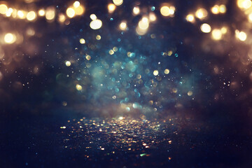 background of abstract glitter lights. gold, blue and black. de focused